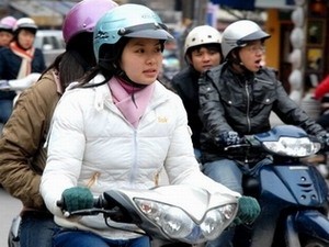 This undated file photo shows motorcyclists during a cold spell in northern Vietnam.